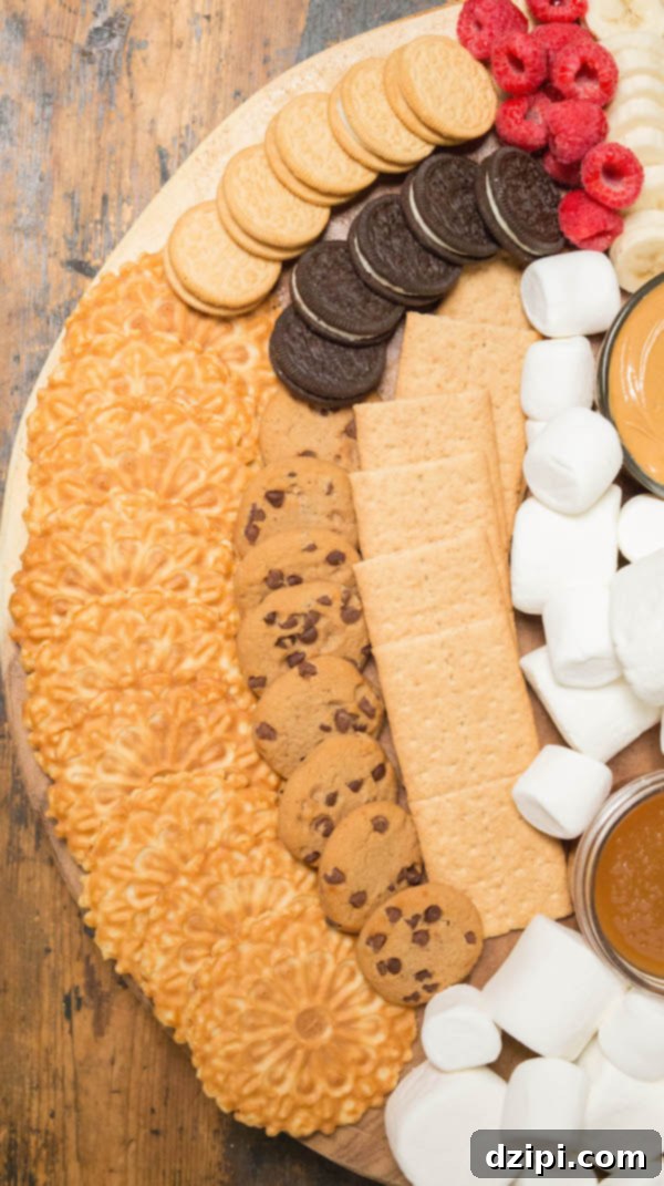 S'mores Creation Station 3 A selection of graham crackers, Oreos, and chocolate chip cookies arranged on a s'mores board, ready for creative s'more combinations.