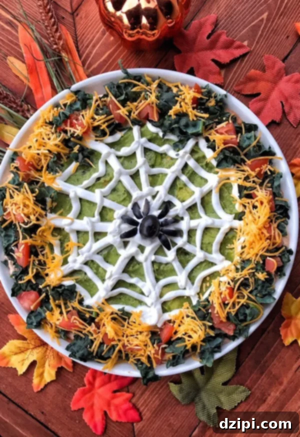 Bewitching Bites 18 Halloween Spider Web Taco Dip Appetizer with olive spider