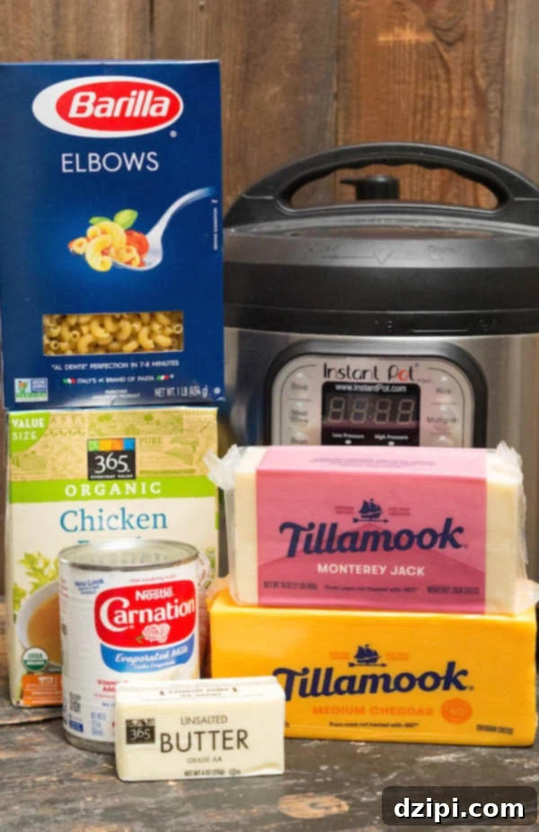 Instant Pot Mac & Cheese Ingredients - cheddar cheese, white cheese, evaporated milk, chicken broth, and elbow pasta displayed.