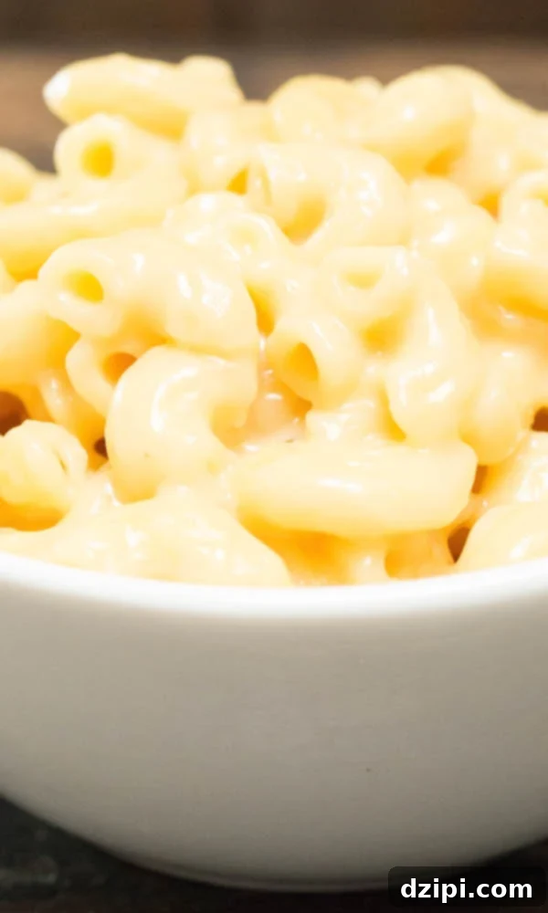 Close up of Instant Pot Mac and Cheese in a white serving bowl, garnished.