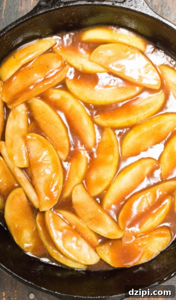 Homemade Sweet Fried Apples 2 Copycat Cracker Barrel Fried Apples in a cast iron skillet, golden brown and glistening.