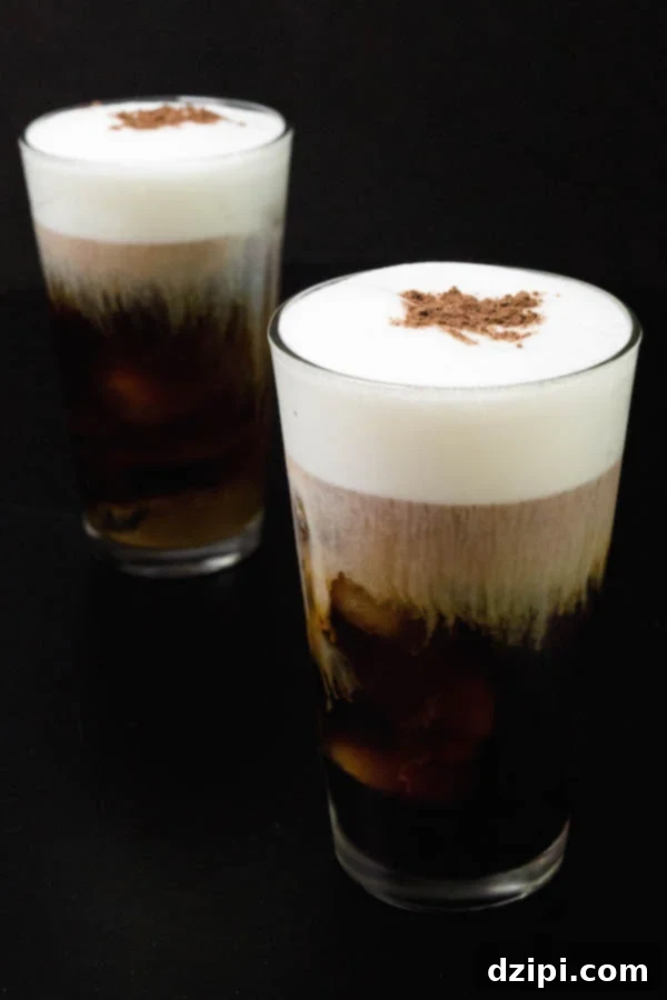 Homemade Starbucks Inspired Irish Cream Cold Brew 3 Two clear pint glasses filled with perfectly layered homemade Irish Cream Cold Brew, showcasing the rich coffee and creamy foam.