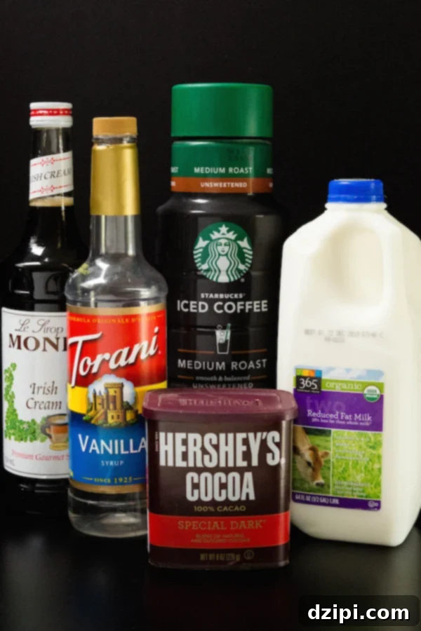 Homemade Starbucks Inspired Irish Cream Cold Brew 4 An array of ingredients laid out, including cold brew coffee, Irish cream syrup, vanilla syrup, milk, and cocoa powder, ready for making the Irish Cream Cold Brew.