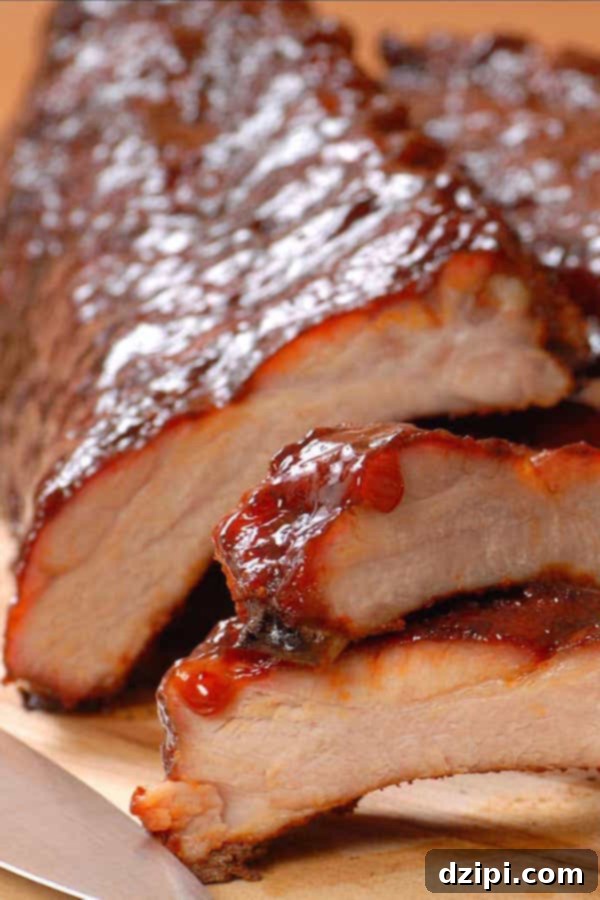 Clone Your Favorite Restaurant Meals At Home 17 Close up of a slab of BBQ ribs with two ribs cut off and in the foreground