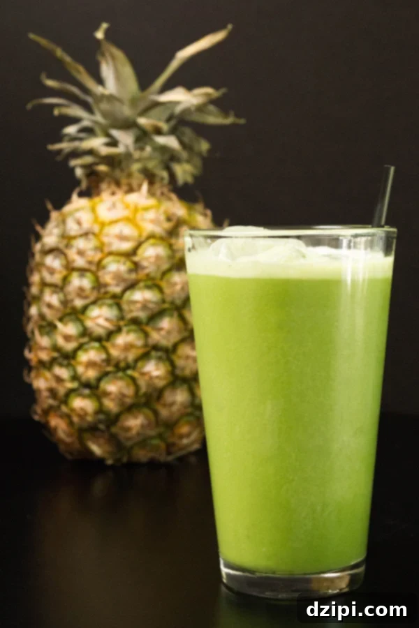 Homemade copycat Starbucks Matcha Pineapple Drink on a sleek black background, showcasing its vibrant green color.