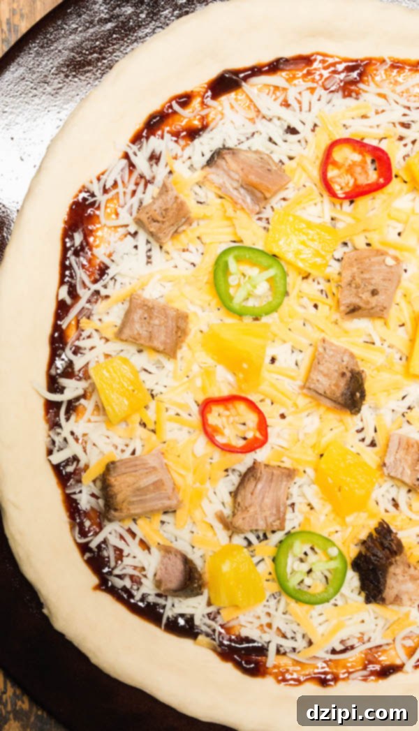 Tropical BBQ Pulled Pork Pizza 3 An uncooked pizza dough, generously topped with a layer of tangy BBQ sauce, a medley of shredded mozzarella and cheddar cheeses, tender smoked pulled pork, bright pineapple chunks, vibrant green jalapeño slices, and thinly cut white onions, ready for baking on a pizza stone.