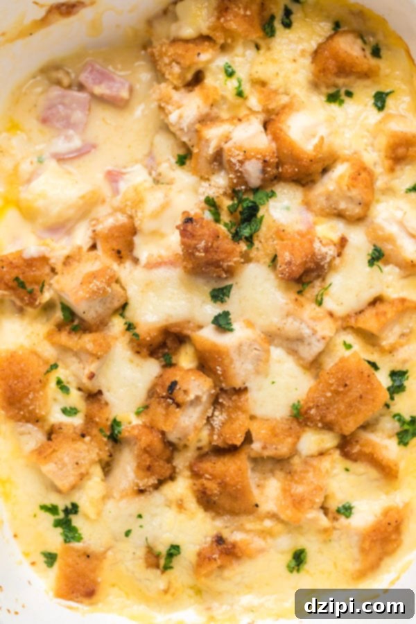 Overhead shot of a chicken cordon bleu casserole, showcasing golden breadcrumbs, melted cheese, and chunks of chicken and ham