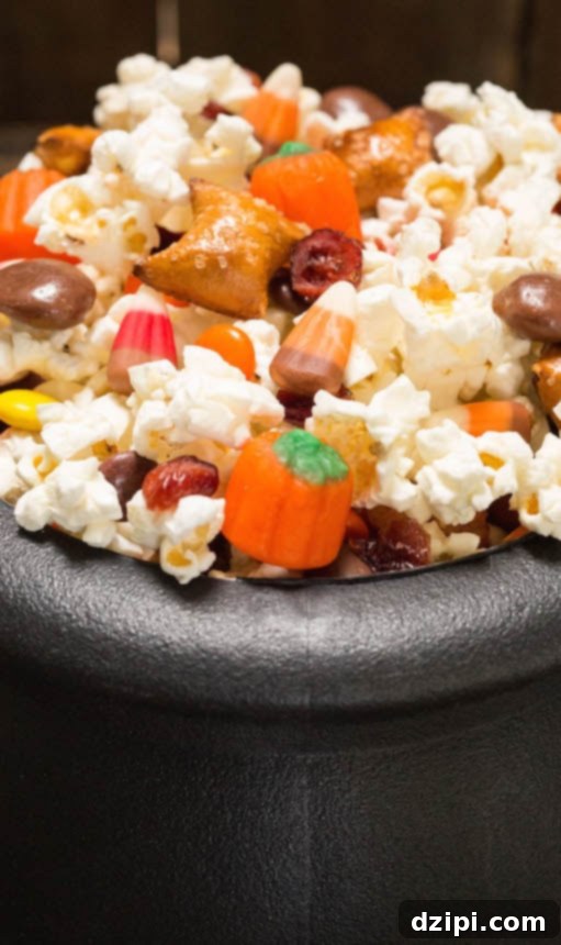 A festive Halloween Snack Mix featuring crunchy popcorn and classic candy corn, perfect for movie night