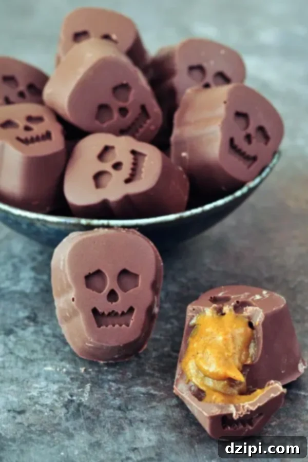 Intricately shaped skull chocolates, split open to reveal a rich, gooey pumpkin caramel filling inside