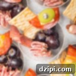 Overhead shot of individual charcuterie cups with a medley of gourmet items.
