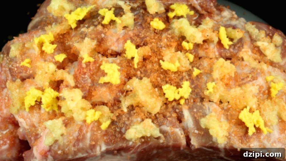 Raw pork in the crock put with grated ginger, minced garlic, and pink salt on top.