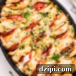An oval casserole dish that's filled with canned biscuits stuffed with pizza toppings to make a casserole.