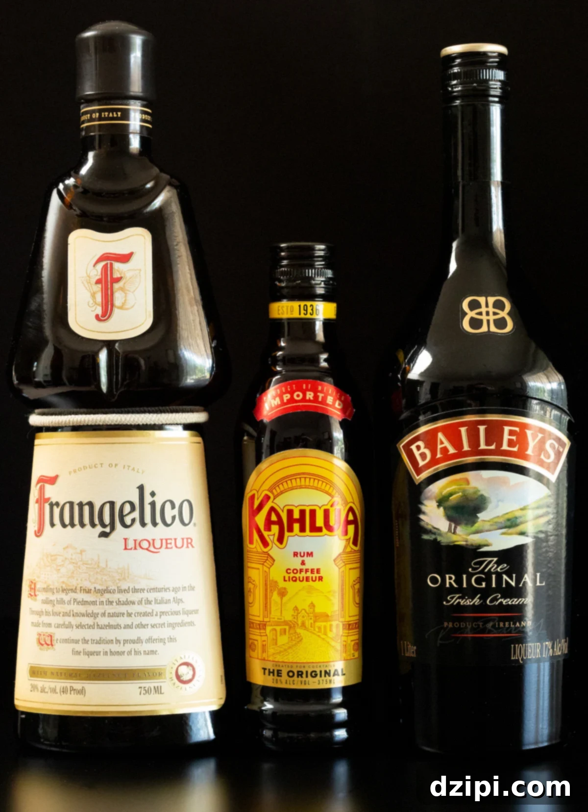 Snickers Shooter 4 A bottle of Frangelico, Kahlua, and Bailey's Irish Cream neatly arranged on a dark background, highlighting the key ingredients.