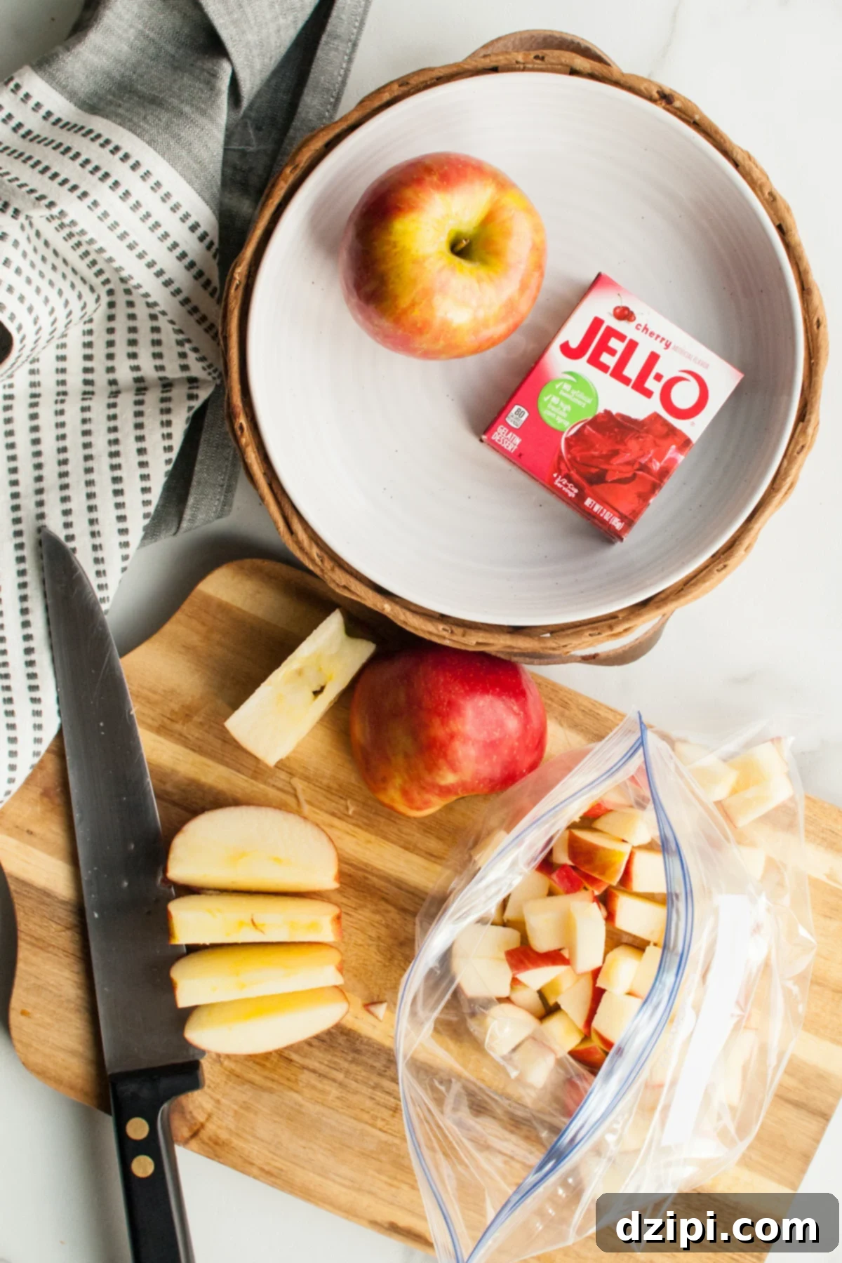 Chopped apples being put into a Ziploc bag.