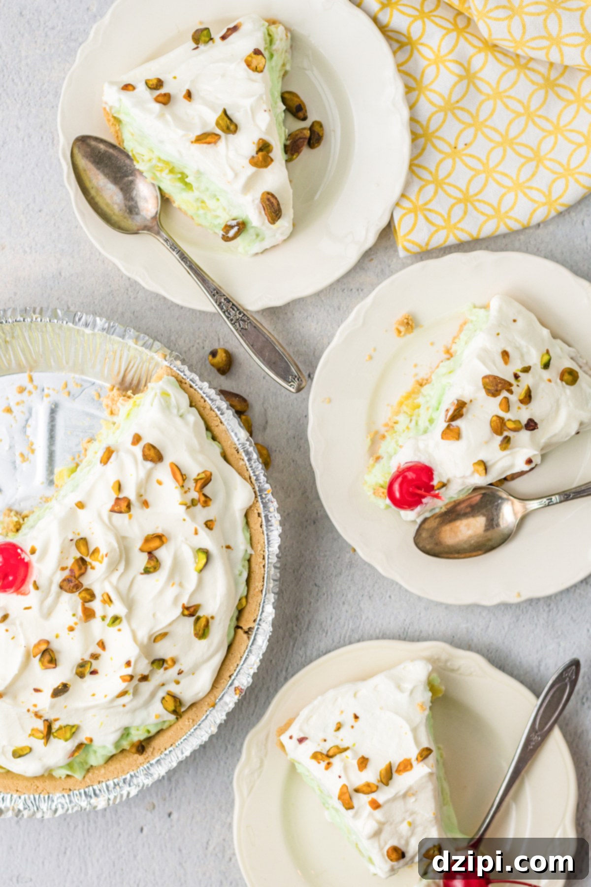 Emerald Dream Pie 5 An overhead shot featuring three generous slices of pistachio pie elegantly arranged on small serving plates, positioned alongside the beautifully cut remaining pie.