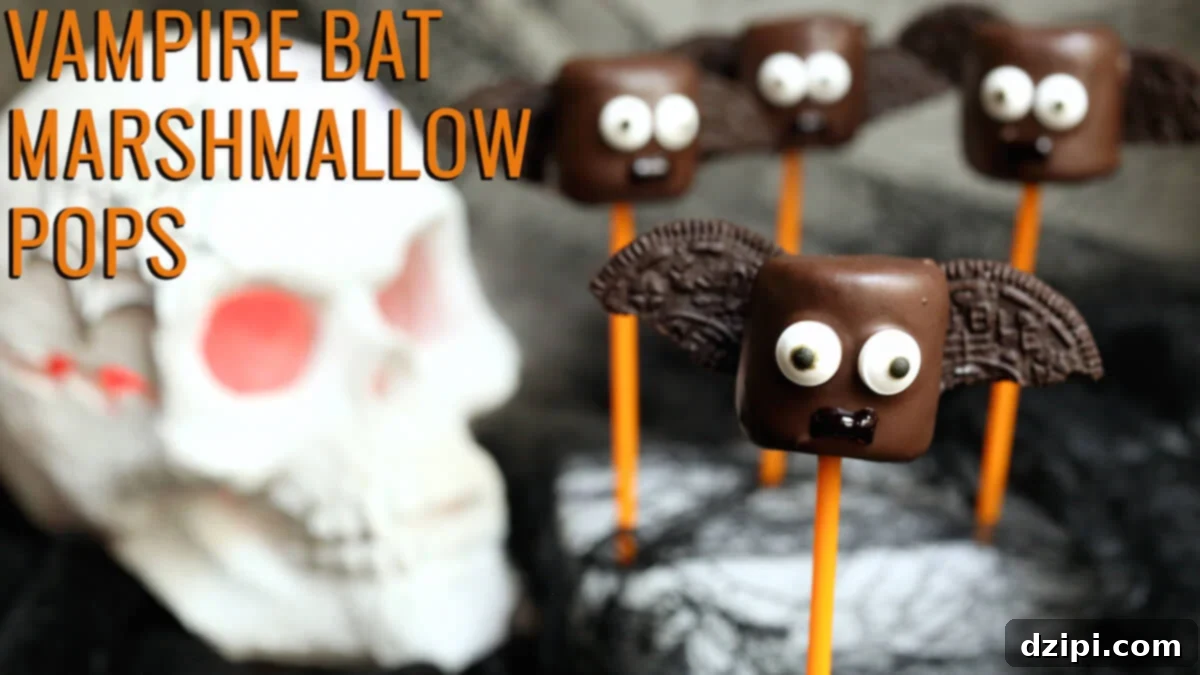 Delightful Vampire Bat Marshmallow Pops: Large marshmallows dipped in rich dark chocolate, adorned with crunchy Oreo halves for wings and sweet candy eyes, perfect for a spooky Halloween treat.