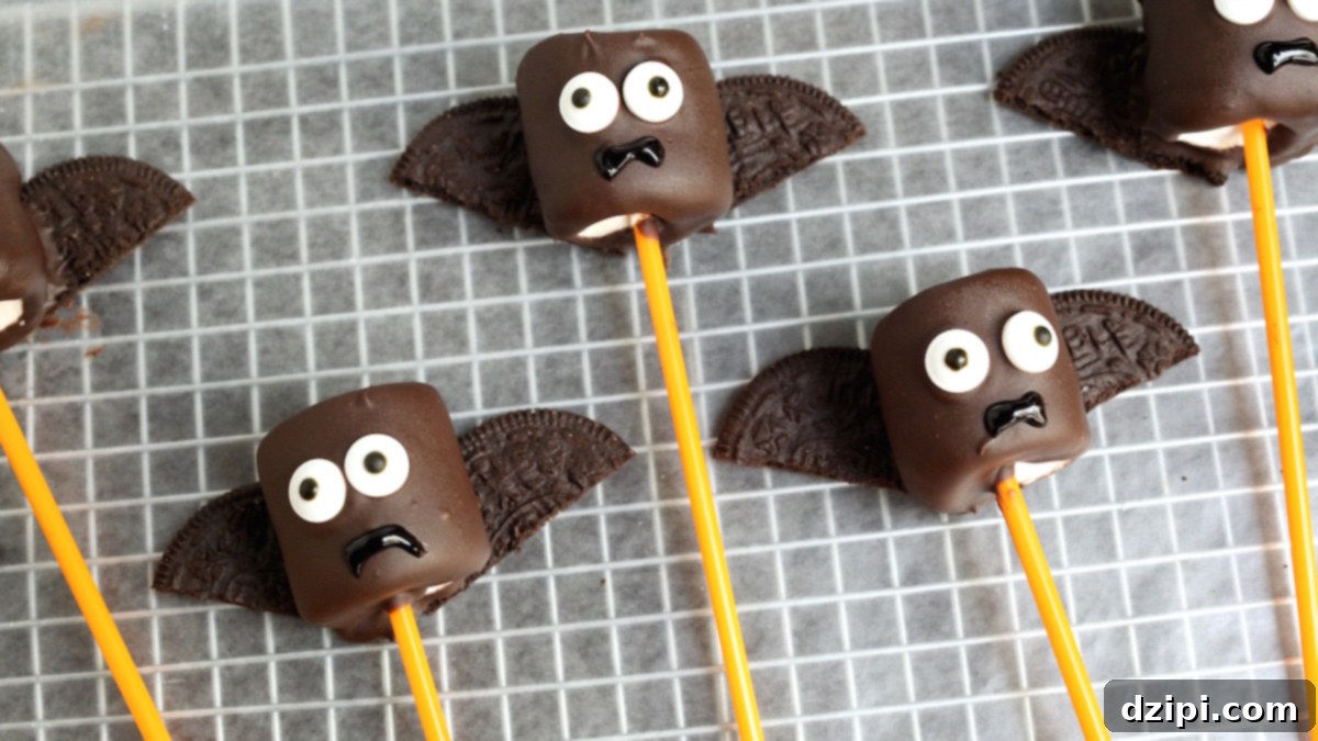 Close-up of a homemade Halloween Vampire Bat Marshmallow Pop with chocolate coating, Oreo wings, and candy eyes, ready for a festive party.