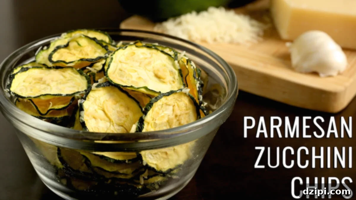 A small glass bowl is full of dehydrated zucchini slices. Text reads "Parmesan Zucchini Chips"