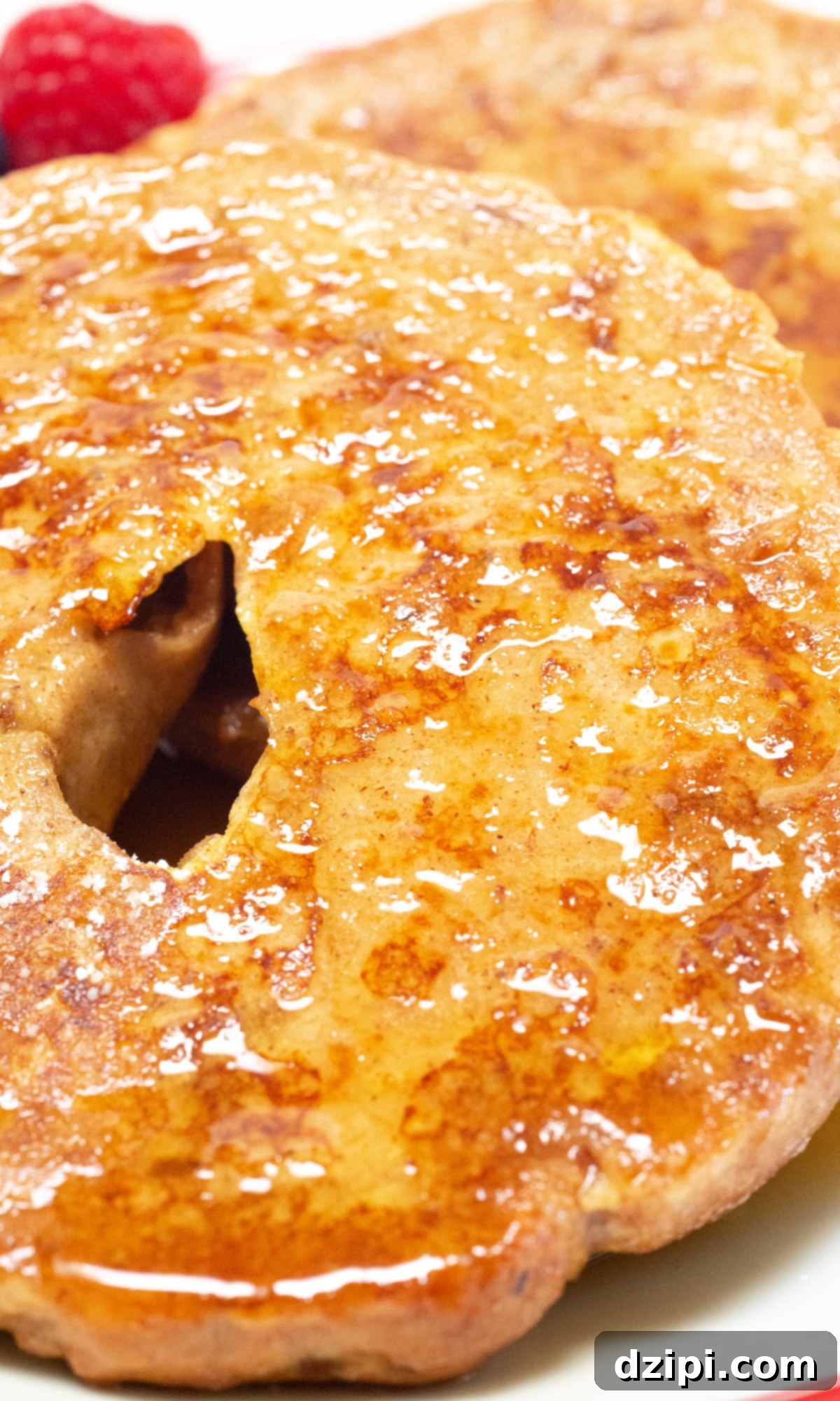 Maple Glazed French Toast Bagel 3 Close up of a french toast bagel that's been covered in syrup.