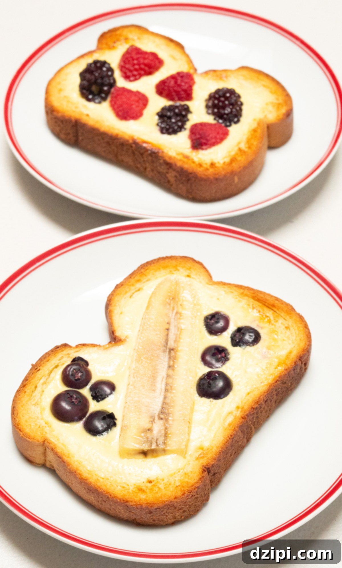 Two dinner plates each with a slice of yogurt custard toast topped with fresh fruit.