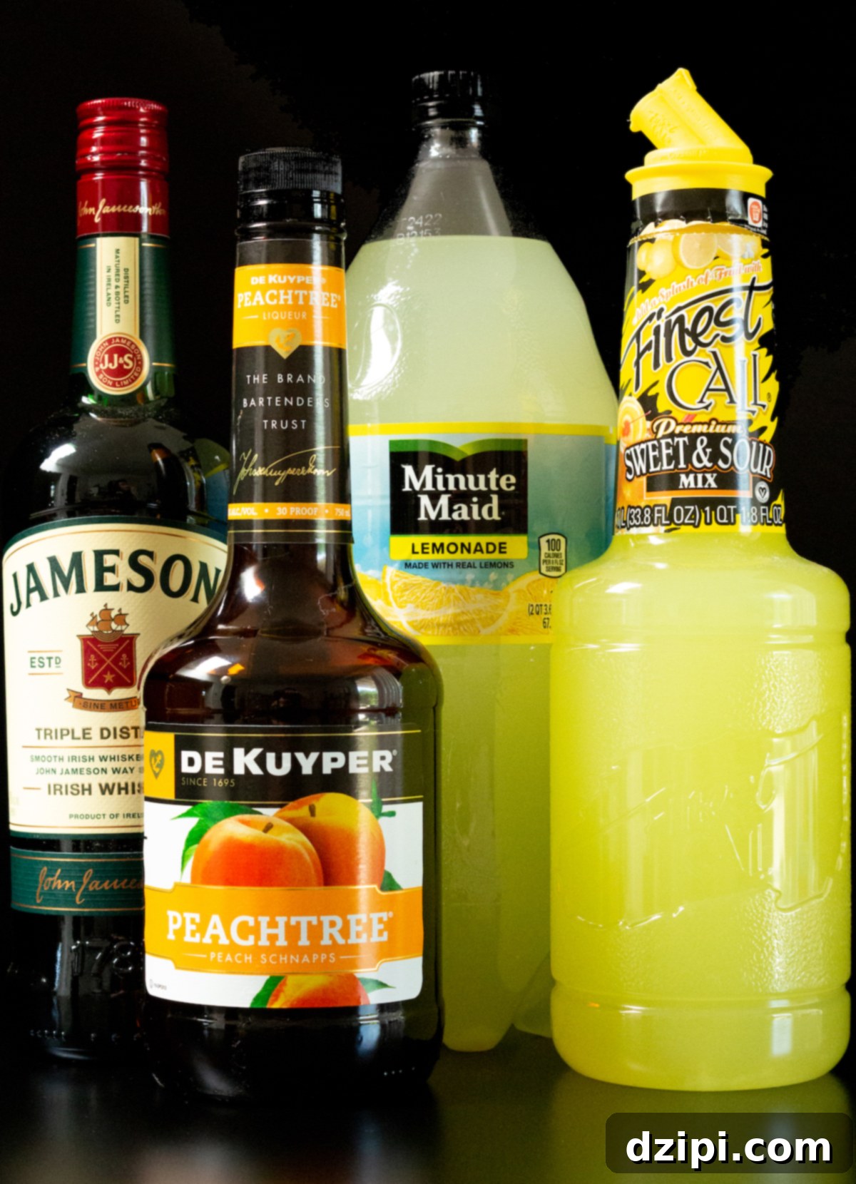 A selection of high-quality Green Tea Shot ingredients: a bottle of Jameson Irish Whiskey, peach schnapps, a bottle of sour mix, and a carton of lemonade, artfully arranged on a sleek black background.