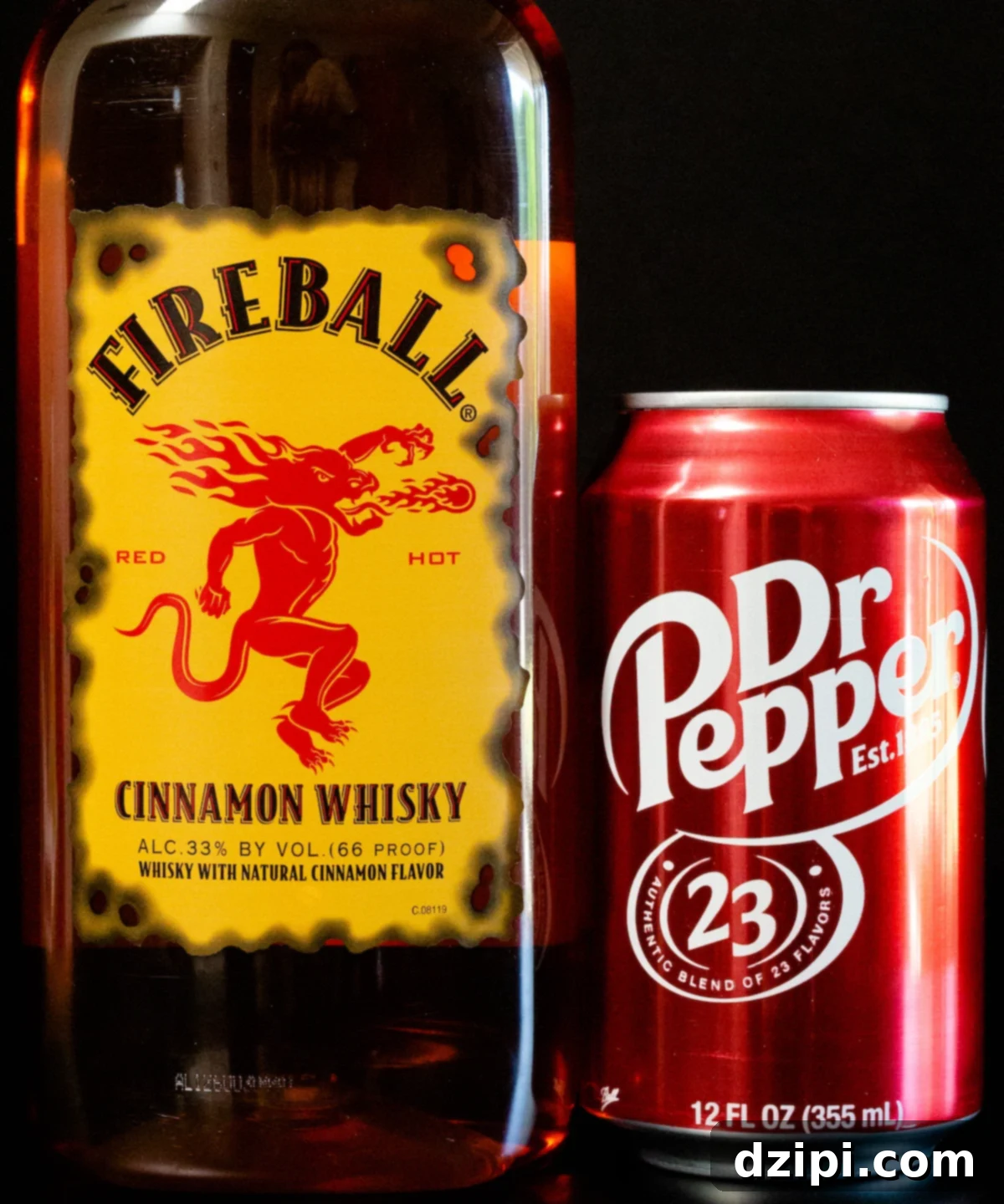 A bottle of Fireball whiskey and a can of Dr. Pepper on a black background, the two primary ingredients for this easy cocktail.