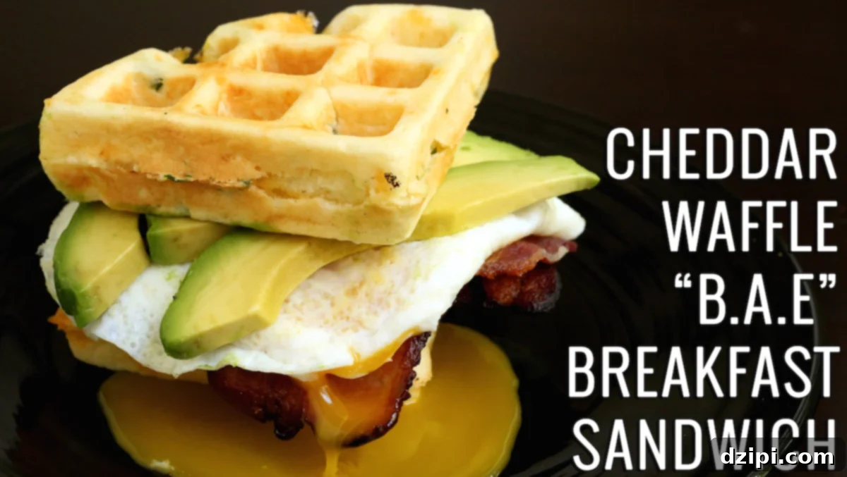 Delicious Cheddar Waffle BAE Breakfast Sandwich with bacon, fried egg, and avocado on savory waffles