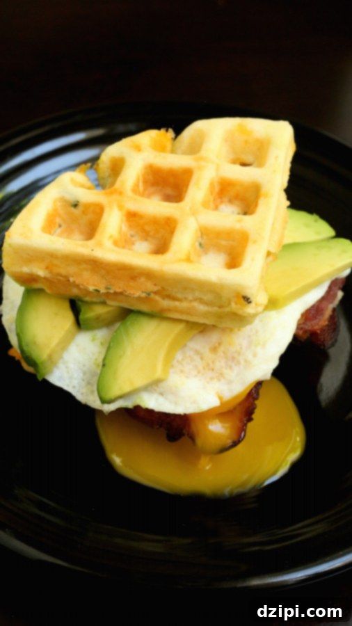 Cheddar Waffle BAE Breakfast Sandwich beautifully plated, showcasing the layers of bacon, avocado, and egg