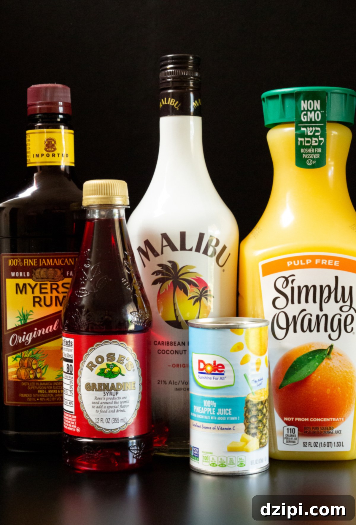 Individual ingredients for a Bahama Momma cocktail displayed on a black background, including bottles of rum, grenadine, and glasses of juice.