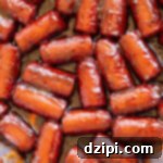 A disposable foil pan filled with hot dog burnt ends.