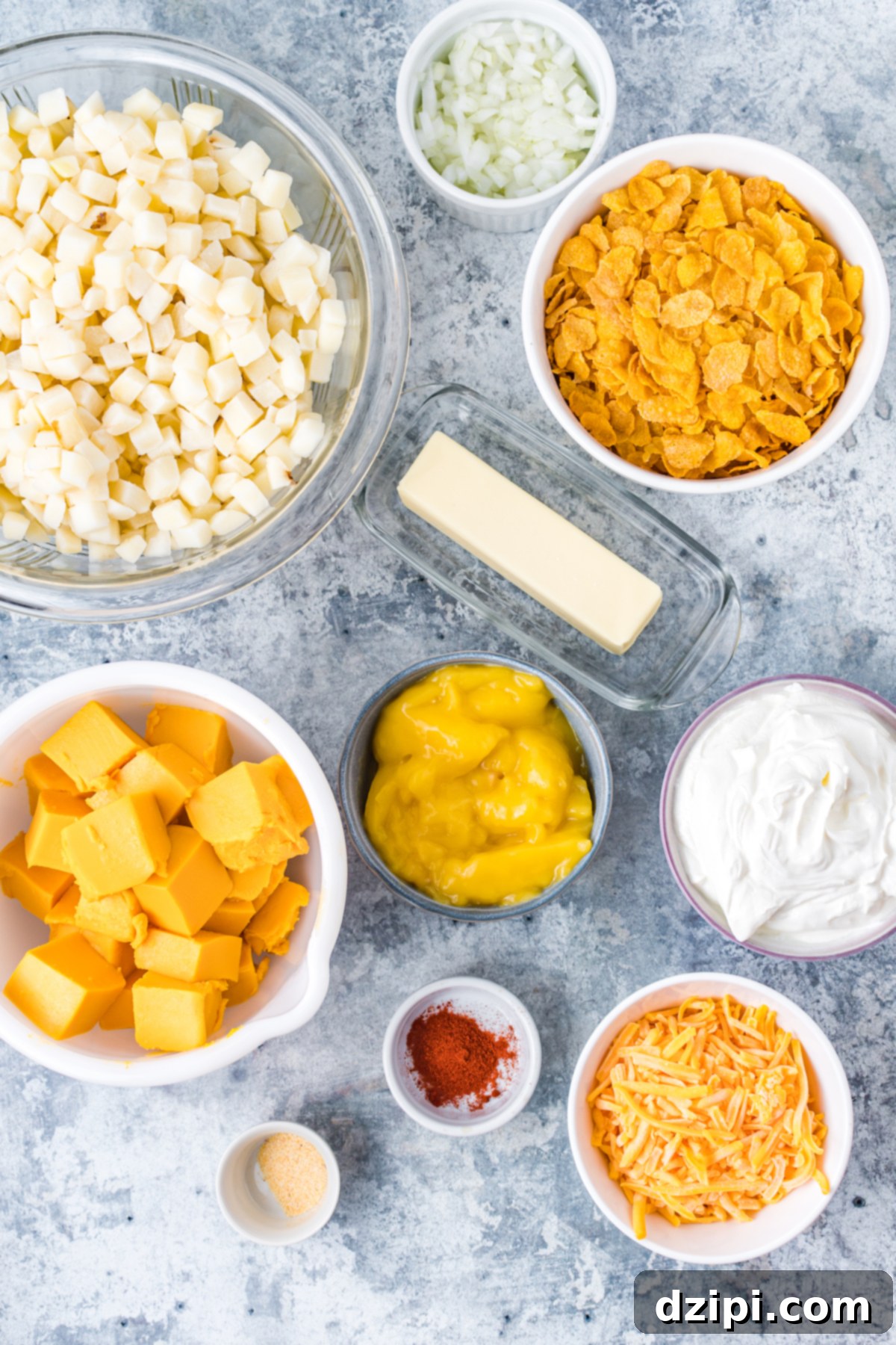 All the ingredients to make funeral potatoes in prep bowls on a countertop.