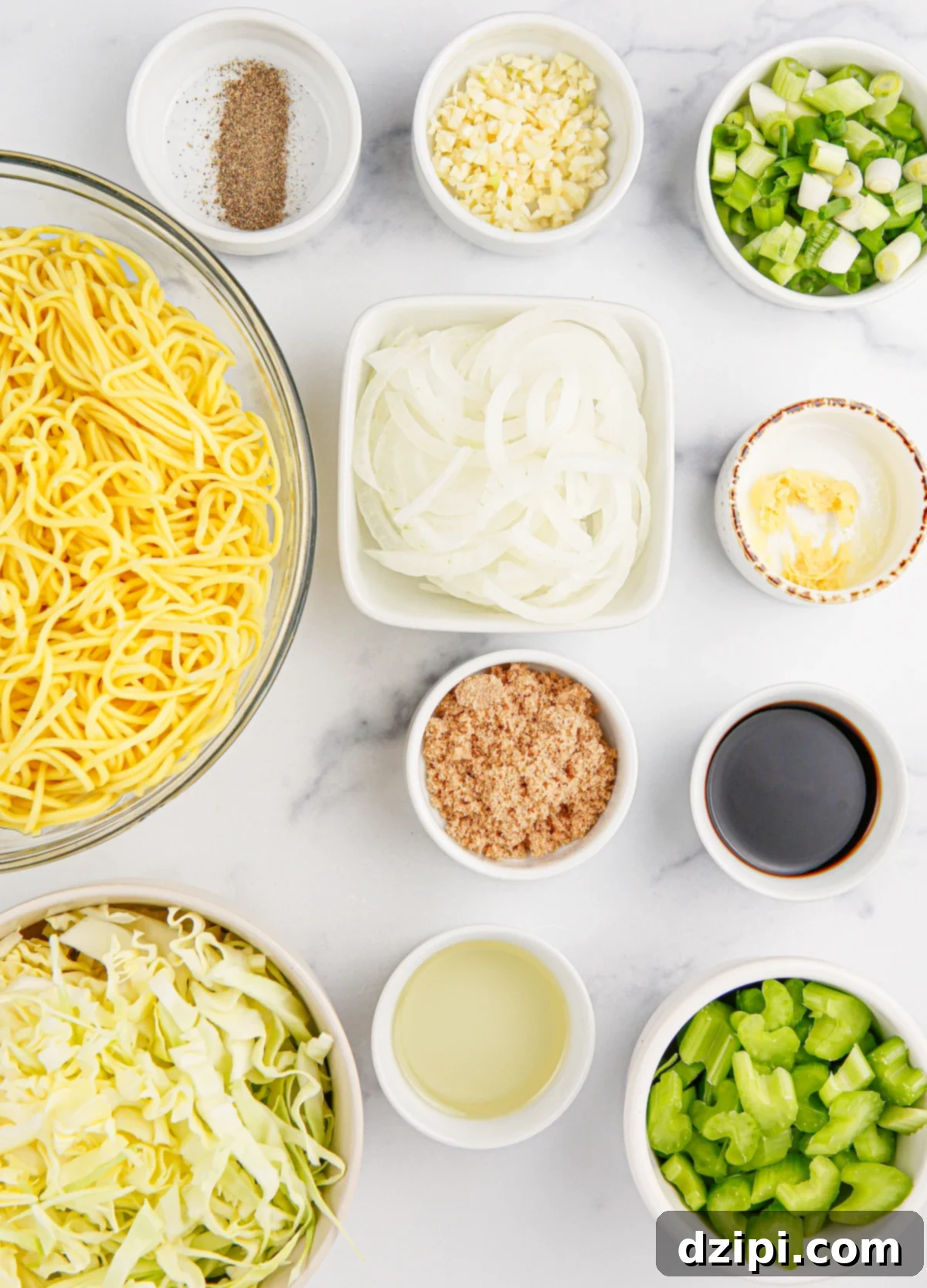 Iconic Panda Express Chow Mein 4 All the fresh ingredients to make delicious Panda Express chow mein laid out in prep bowls on a pristine white marble background.