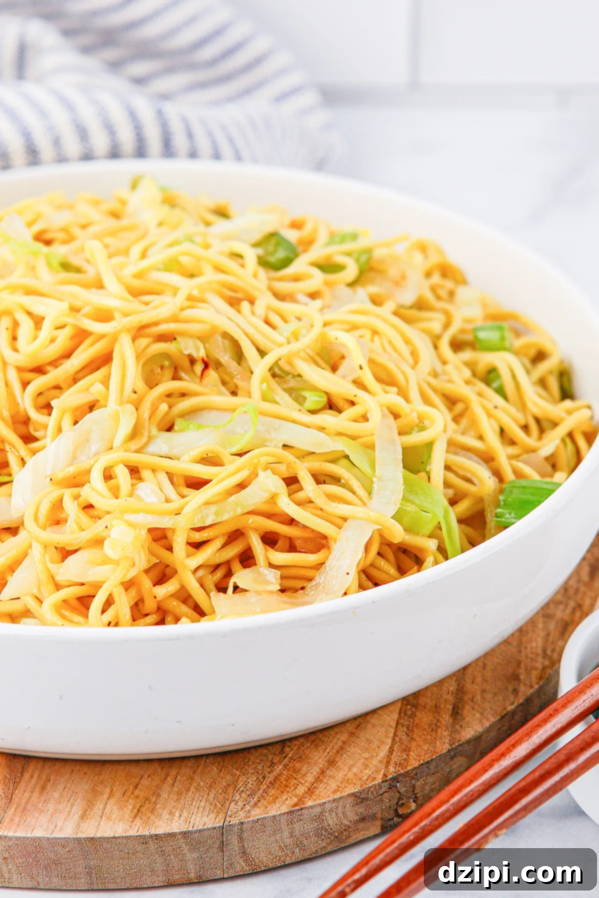 Iconic Panda Express Chow Mein 7 A detailed close-up of a white serving bowl generously filled with homemade Panda Express Chow Mein noodles, showcasing their irresistible texture and vibrant ingredients.