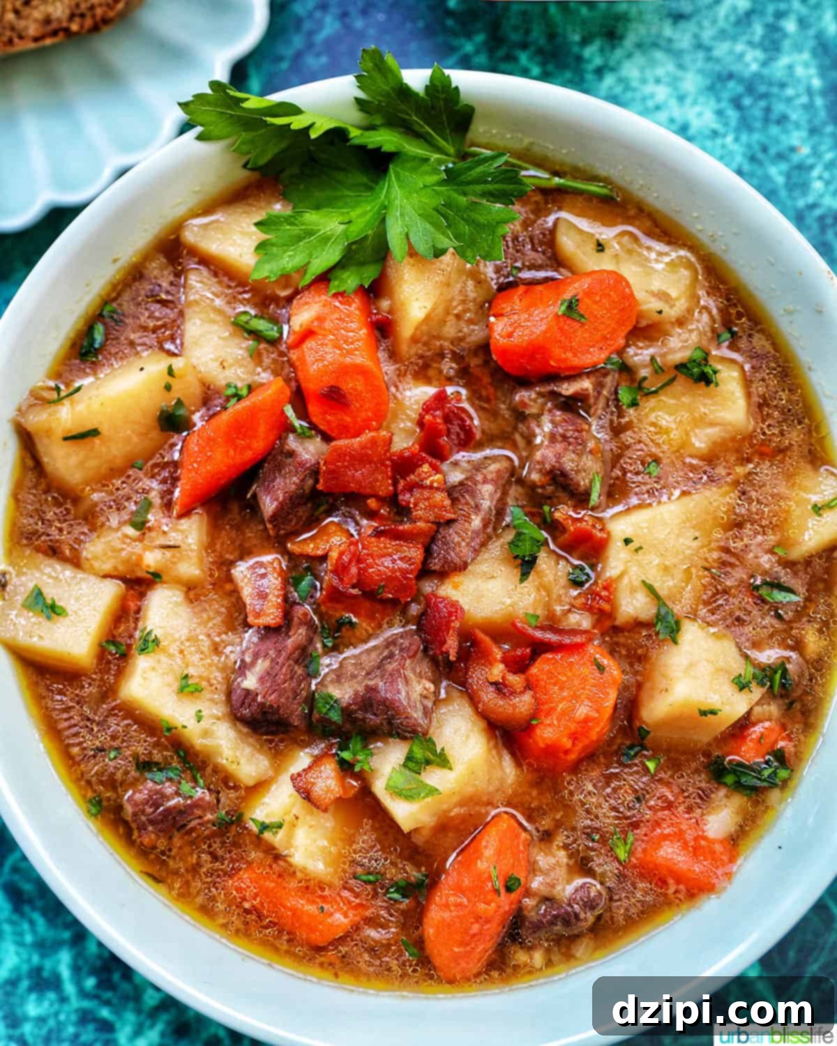 A large, rustic soup bowl filled with hearty Instant Pot Irish Lamb Stew, featuring chunky, tender lamb pieces, potatoes, carrots, and onions in a rich, savory broth.