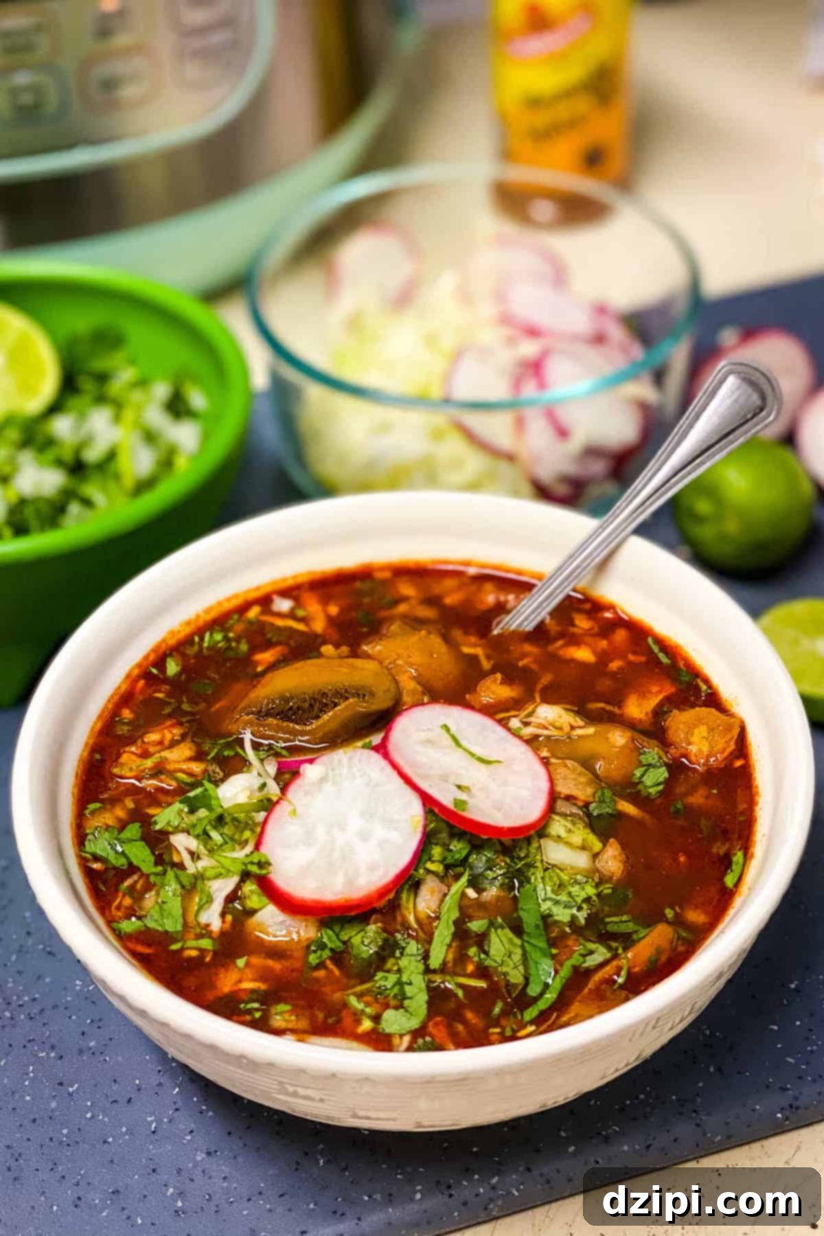 A vibrant bowl of vegan Instant Pot Pozole, elegantly garnished with crisp sliced radishes and fresh herbs, positioned in front of glass prep bowls filled with key ingredients.