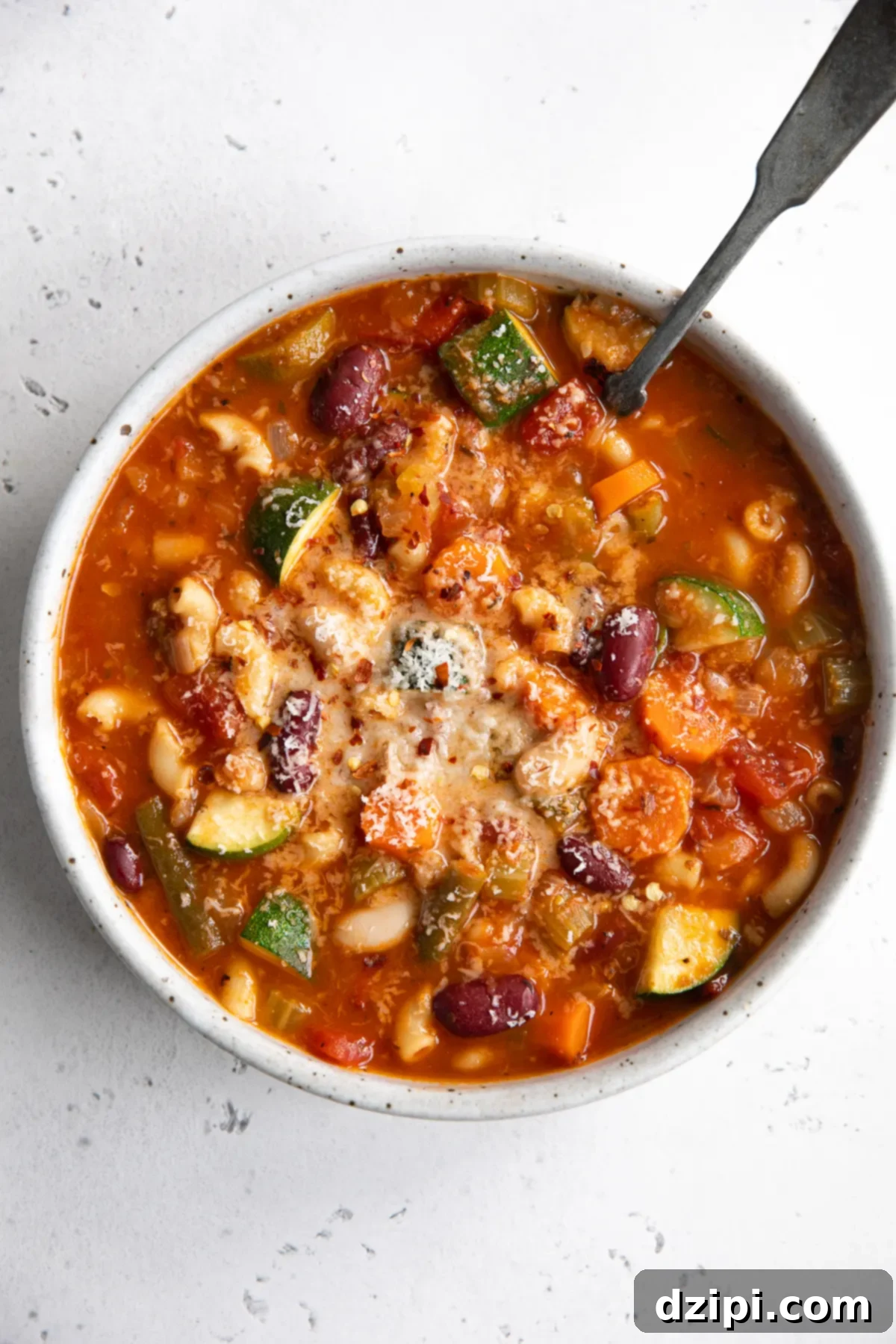 Overhead view of a generous bowl filled with vibrant and wholesome Instant Pot Minestrone soup, brimming with colorful vegetables, pasta, and beans.