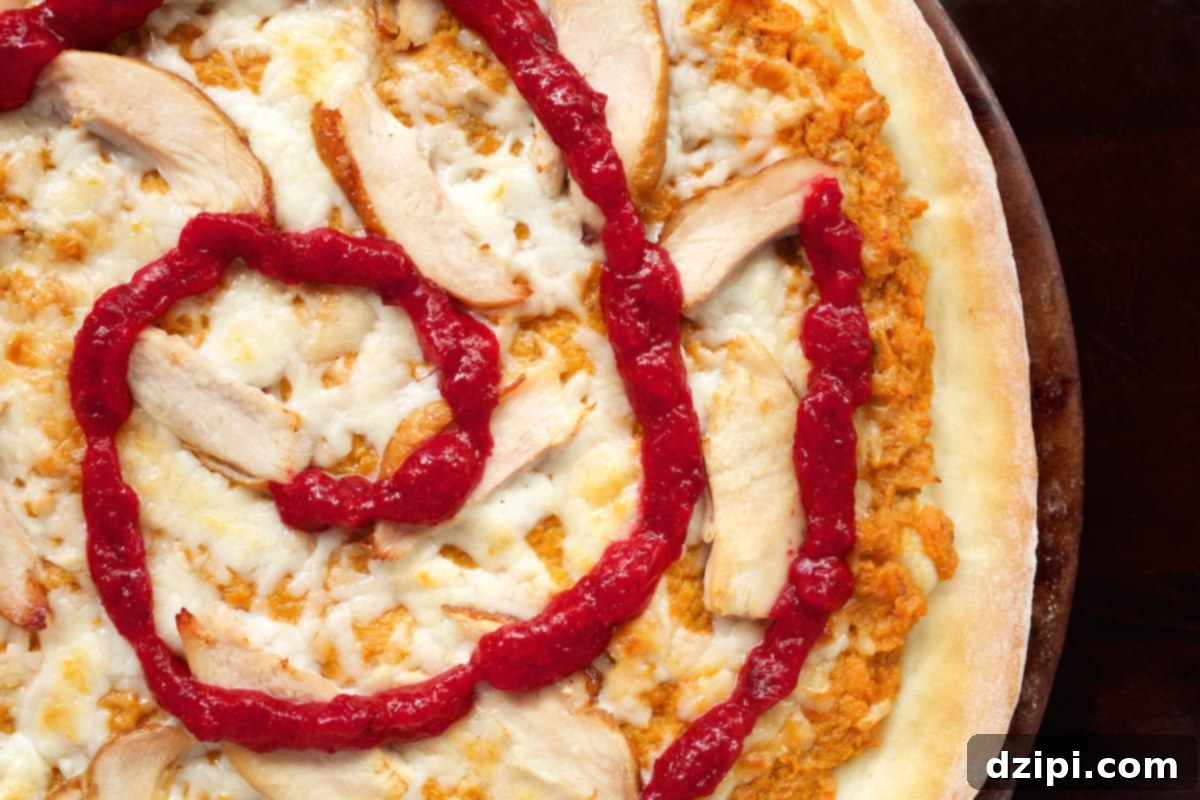 Thanksgiving Leftovers Pizza with cranberry sauce swirl.