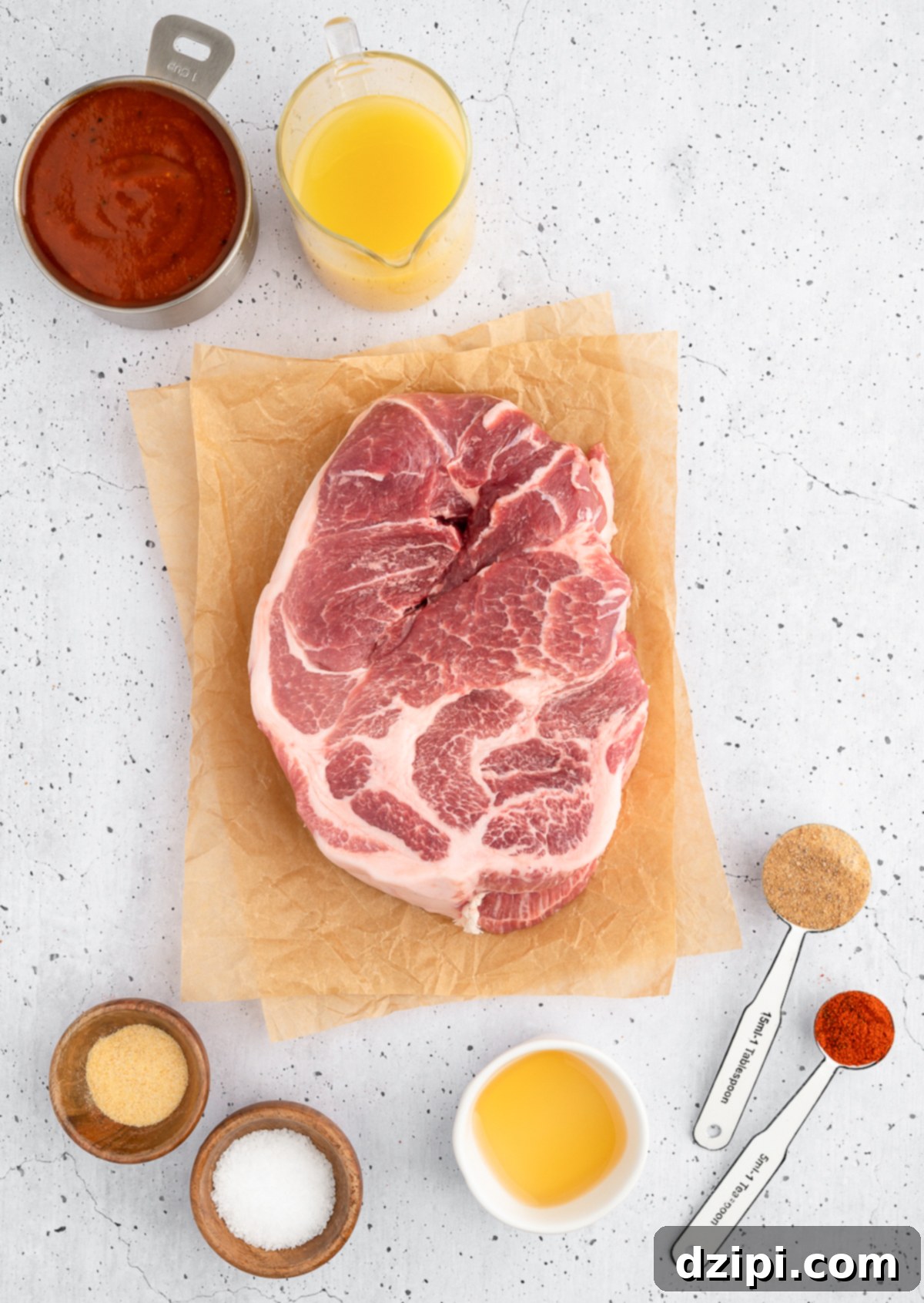 Juicy Instant Pot Pulled Pork 4 An overhead shot showcasing all the raw ingredients neatly arranged for making Instant Pot pork butt, including a large piece of pork, various spices, and bottles of liquid.
