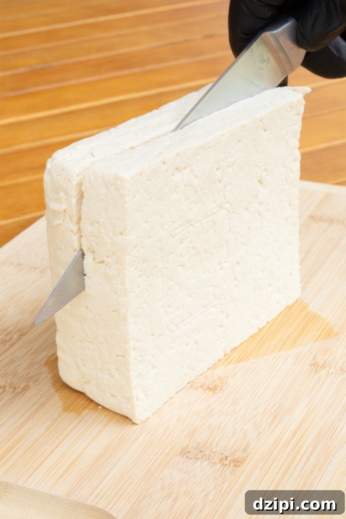 Block of tofu sliced in half.