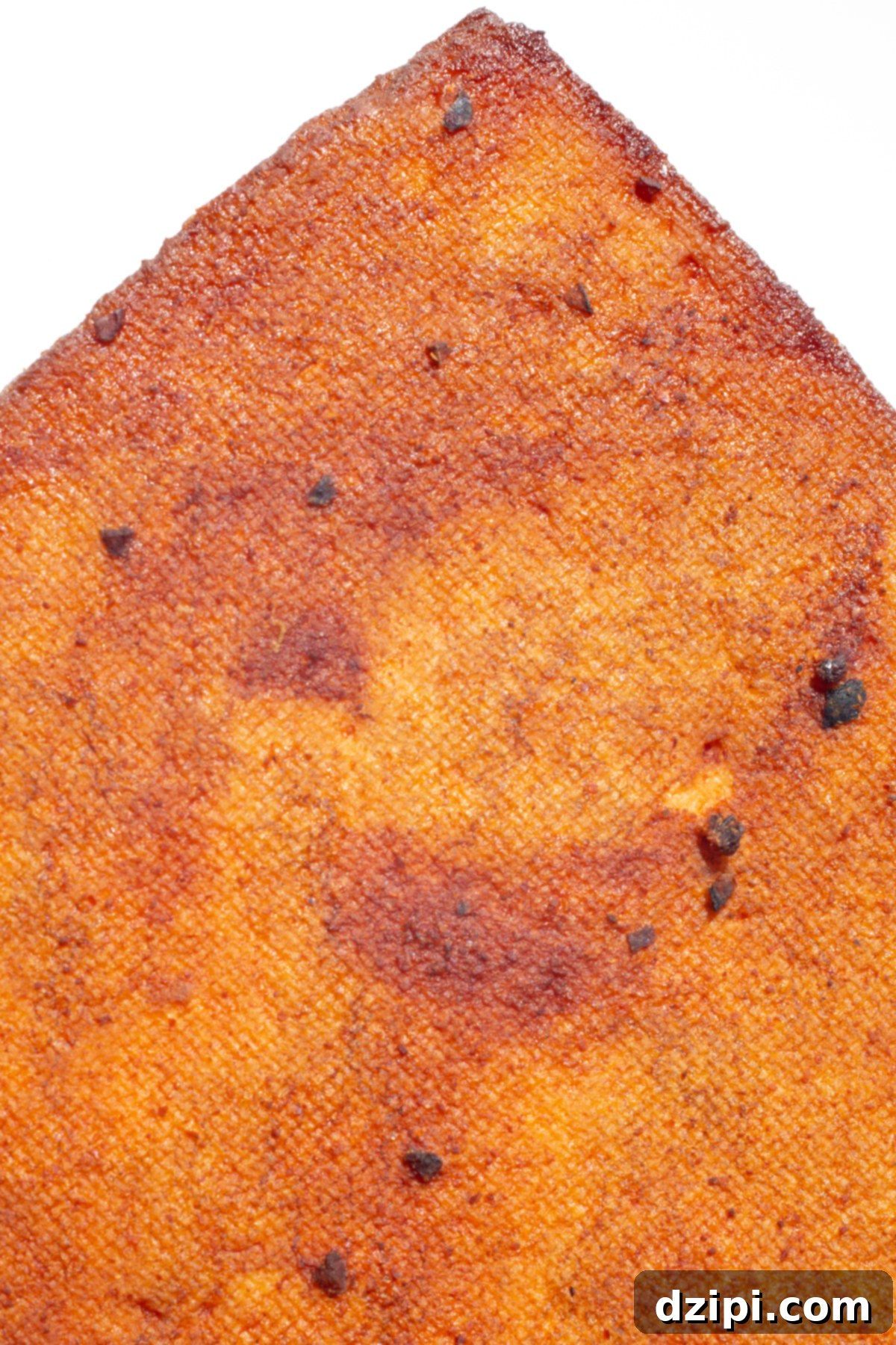 Close up of a block of tofu that's been marinated in bbq sauce then smoked. 