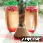 Christmas Champagne Cocktail with Pomegranate and Homemade Simple Syrup, a vibrant and festive drink for the holidays.