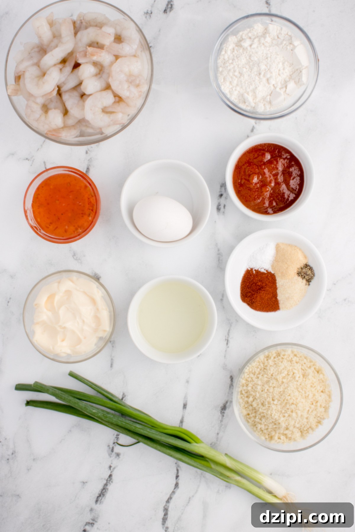 All the ingredients needed to make air fried bang bang shrimp laid out in small prep bowls.
