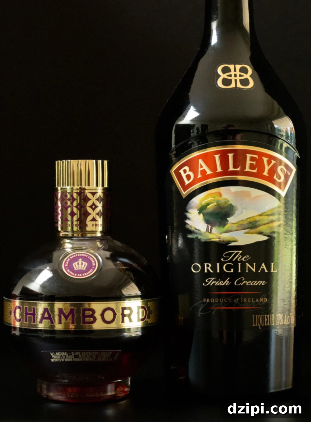 Jam Doughnut Poppers 3 Two key bottles for the Jam Donut Shot: Chambord raspberry liqueur and a rich bottle of Bailey's Irish Cream, elegantly displayed on a sleek black background, ready for mixing.