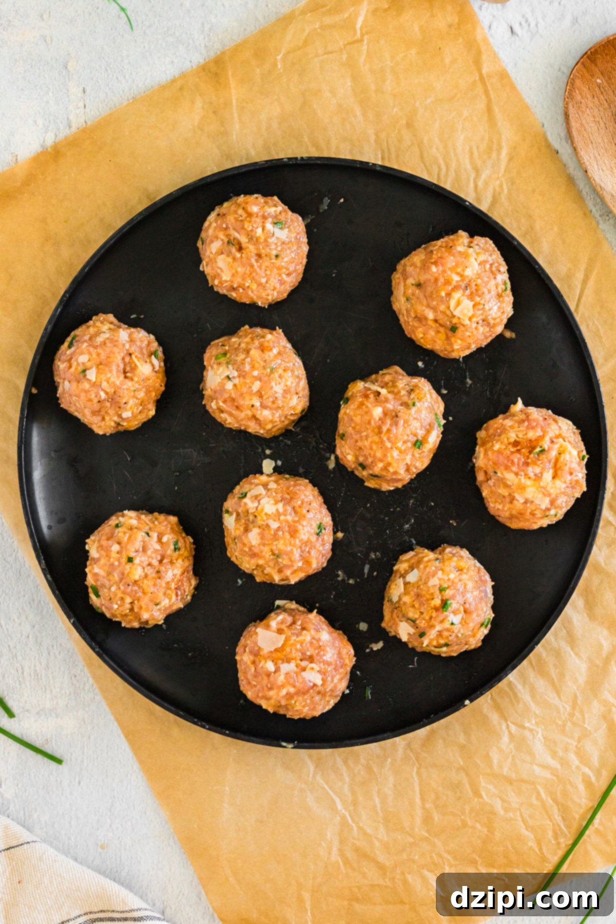 Ten raw firecracker meatballs of equal size on a plate.