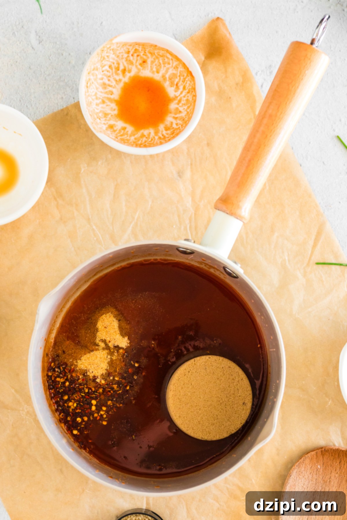 A sauce pan filled with the ingredients needed to make firecracker sauce.