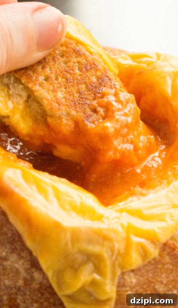 Close-up of Creamy Goat Cheese Tomato Soup in a Grilled Cheese Bread Bowl