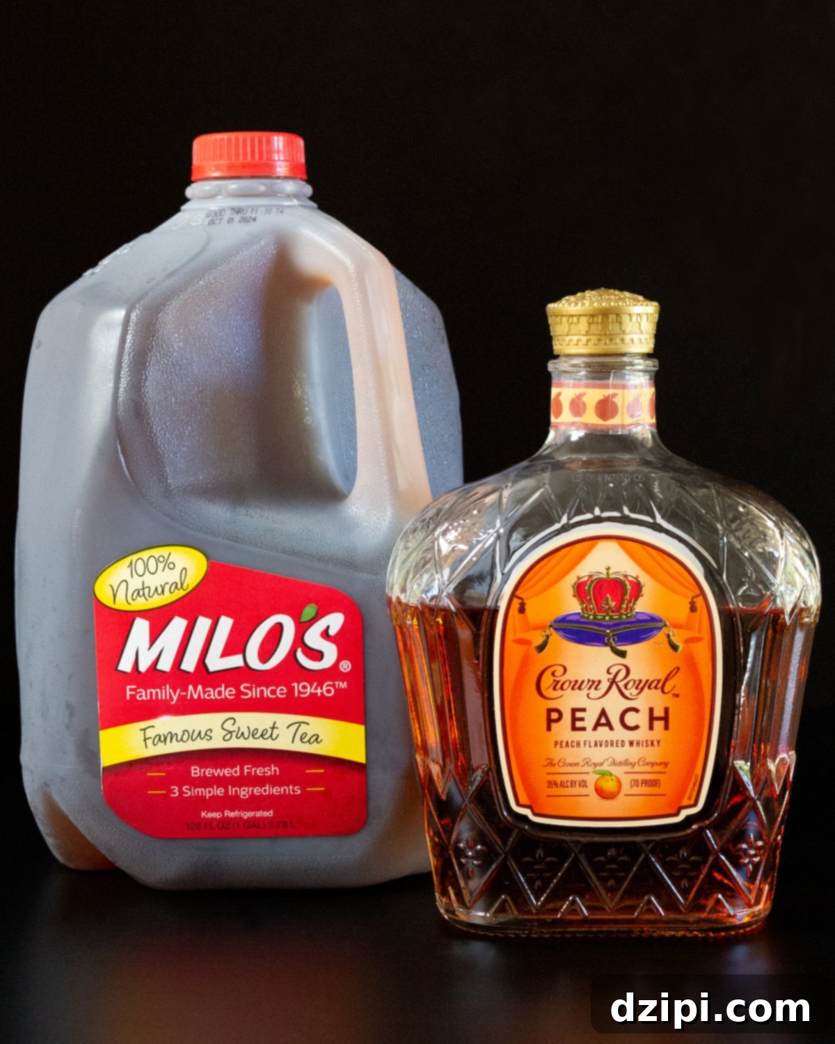 A gallon of Milo's sweet tea and a bottle of Crown Royal Peach on a black background.