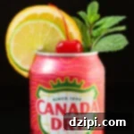 A can of cranberry flavored ginger ale has had the top removed and is garnished with a lime wheel, an orange wheel, a sprig of mint, and a maraschino cherry in the middle.