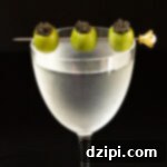A frosted Nick & Nora glass filled with a martini that's garnished with a cocktail pick with three skewered green olives stuffed with caviar.