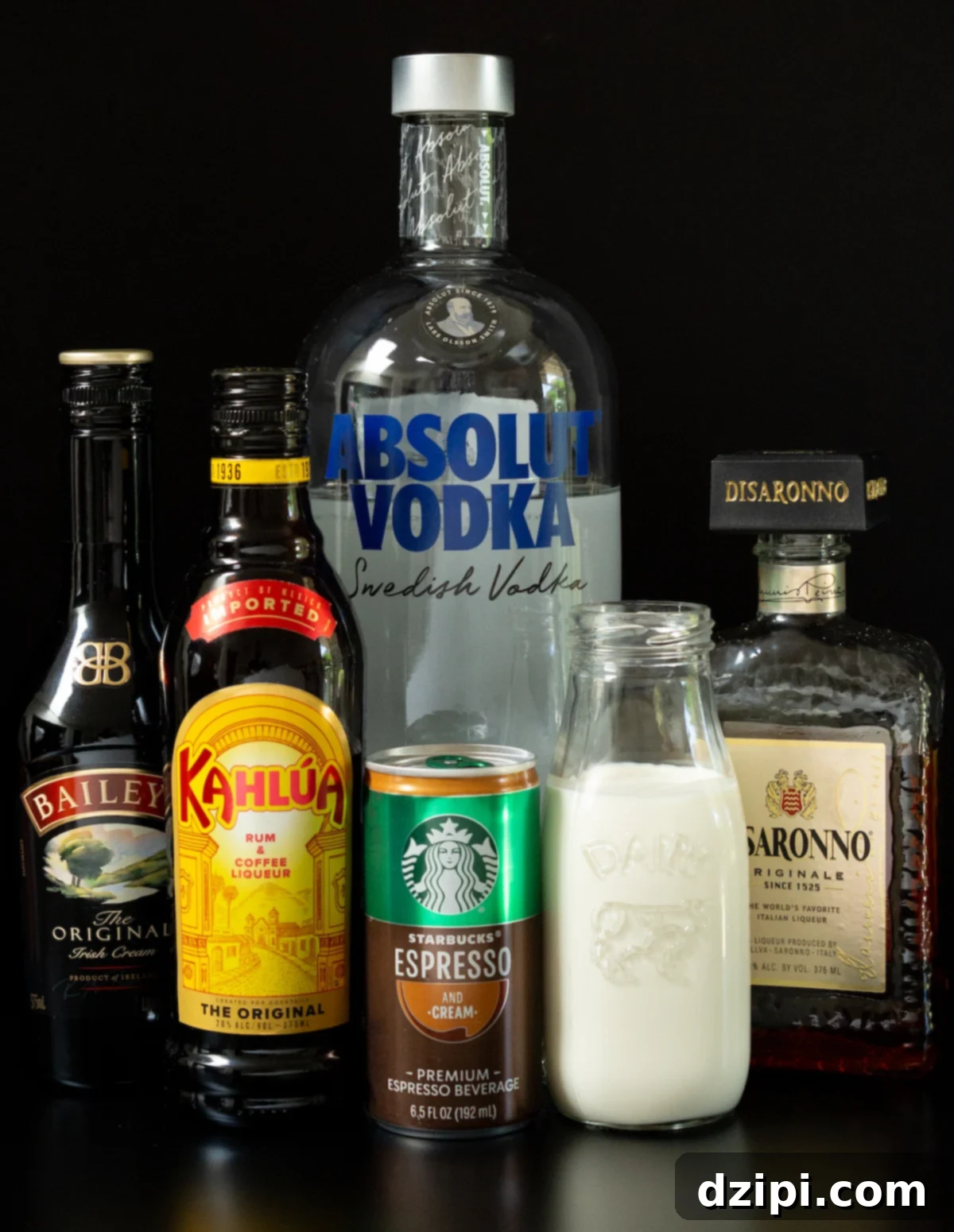 Espresso Martini Unleashed 3 A selection of high-quality ingredients laid out for making espresso martinis, including canned espresso, various liqueurs, and heavy cream.